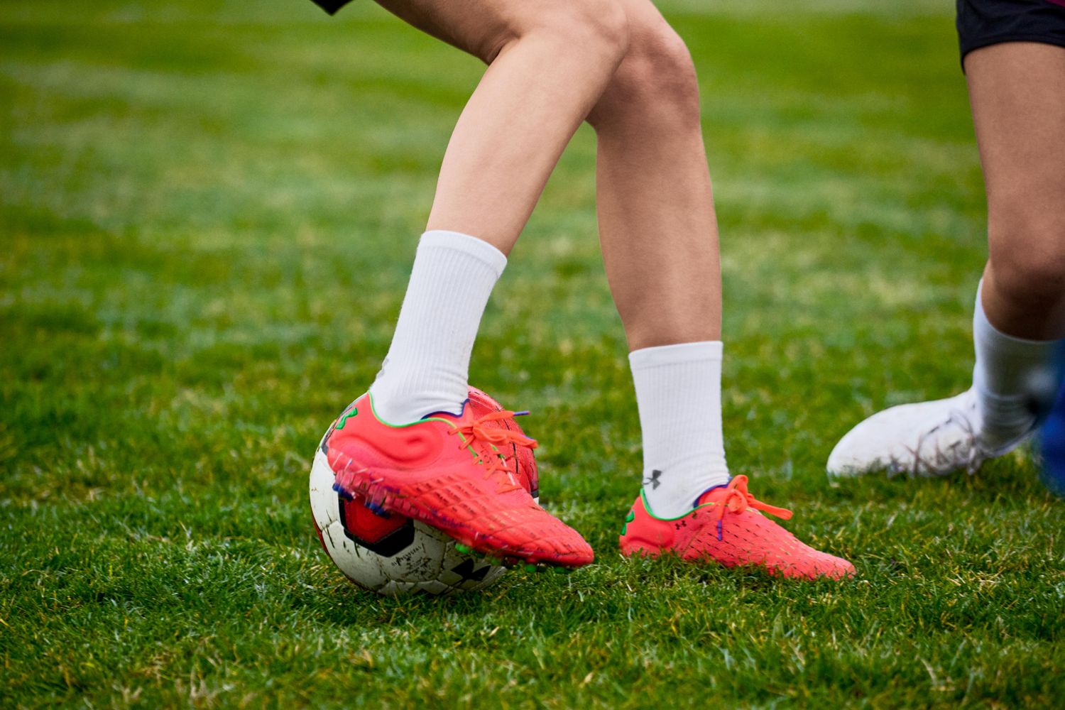 View of red Under Armour soccer cleats.